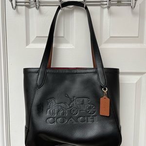 Coach black purse with imbossed horse and carriage. Red interior